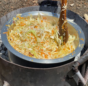 Cooking cabbage, carrots, and onion.